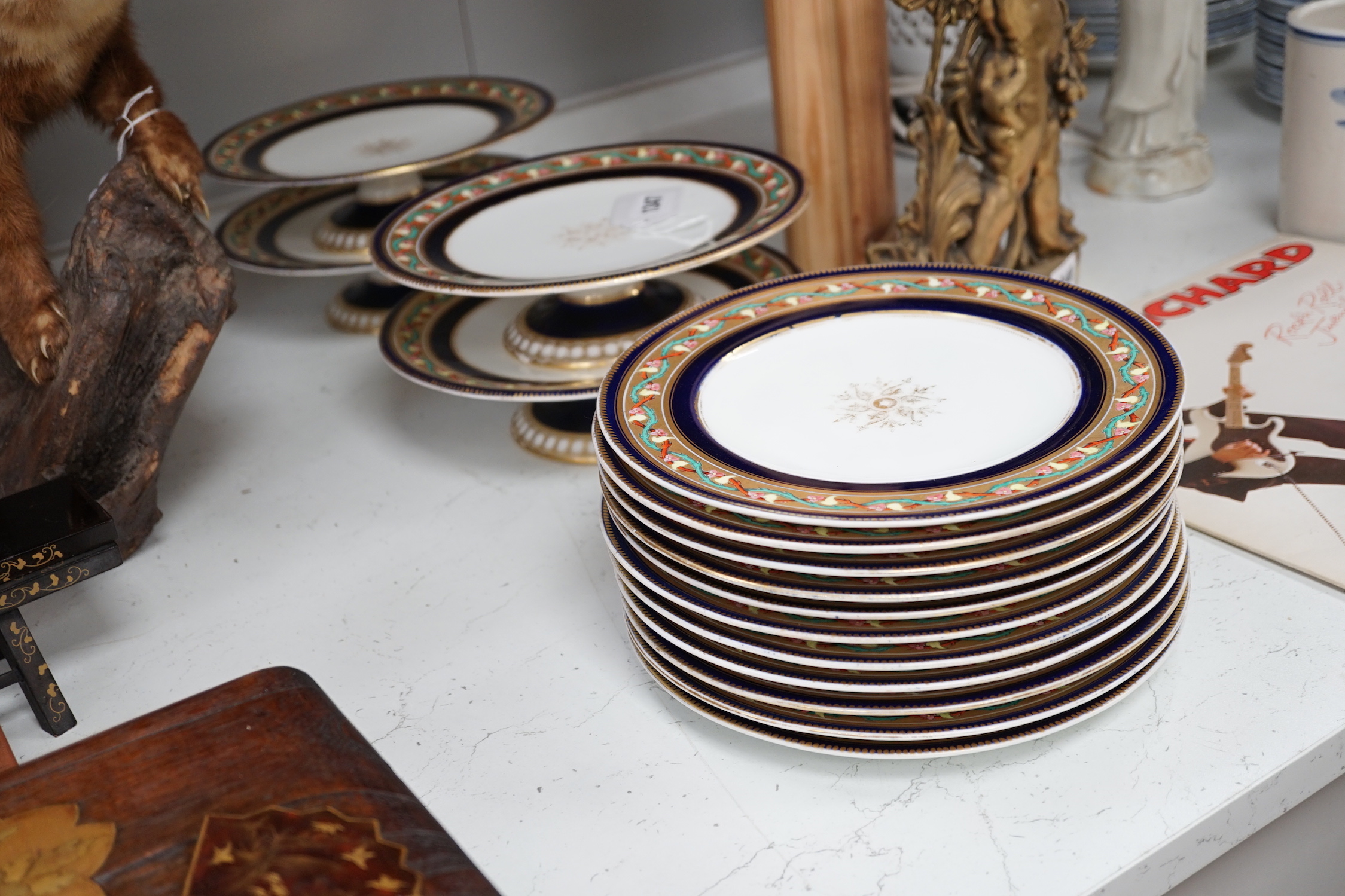 A Victorian bone china dessert service comprising eleven plates and four pedestal dishes, 23cm in diameter